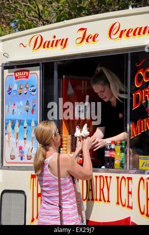 Femme l'achat de la crème glacée à partir du une glace van, Liverpool, Merseyside, England, UK, Europe de l'Ouest. Banque D'Images