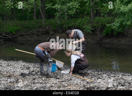 Les élèves du secondaire pour les filets de contrôle indicateurs aquatiques de la qualité de l'eau sur un terrain de l'écologie de la rivière Banque D'Images