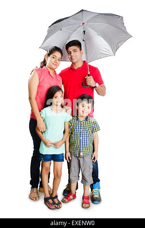 Les parents indiens avec les enfants la protection pluie parapluie Banque D'Images