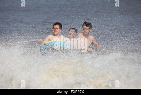 Dalian, province de Liaoning en Chine. Le 13 juillet, 2015. Les gens s'amuser dans la mer le long de la Jinshitan beach à Dalian, Liaoning Province du nord-est de la Chine, le 13 juillet 2015. Les citoyens sont allés à la plage pour échapper à la chaleur de l'été comme lundi marquait le premier jour de dog days. © Piao Feng/Xinhua/Alamy Live News Banque D'Images