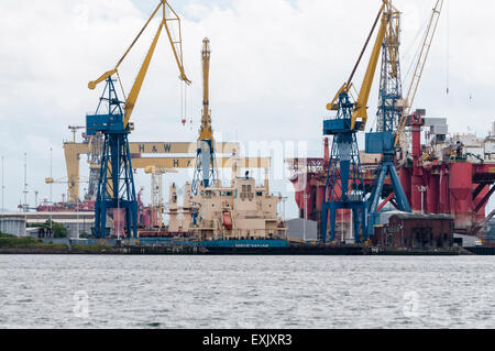 Chantier naval Harland and Wolff avec un navire de forage et en réparation. Banque D'Images