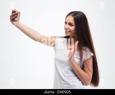 Happy young woman photo selfies palm en agitant isolé sur fond blanc Banque D'Images