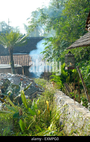 Une épaisse fumée d'un feu de joie sur la pollution de l'air par le sol des déchets dans un village de java indonésie Banque D'Images