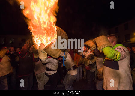 Grand men's barrel en cours au travers des foules sur la place pour marquer le Bonfire Night, 5 novembre, à la tar de barils festival, Honiton, Devon, Angleterre Banque D'Images