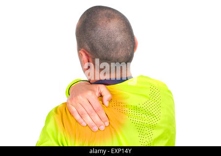 Closeup of a young caucasian sportsman portant des vêtements de sport avec sa main dans son dos à cause de son mal de dos Banque D'Images