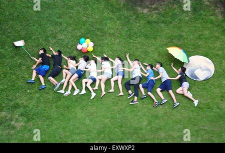 Linyi, Shandong, CHN. 16 juillet, 2015. Shanghai, Chine - 16 juillet 2015 : (usage éditorial uniquement. Chine OUT)Prenons une photo avec le pluton. Les amateurs d'astronomie de l'institut des langues étrangères de Shanghai University prendre de nombreuses photos avec un mini fait main 'Pluto'' de manière créative pour encourager eux-mêmes d'explorer le monde avec courage. Le 14 juillet 2015 dans l'Est des États-Unis d'Amérique, scentists a reçu les signaux des 'Nouveaux horizons'' engins de 5,2 milliards de kilomètres pour s'assurer qu'il a été daté le pluton. Crédit : SIPA Asie/ZUMA/Alamy Fil Live News Banque D'Images