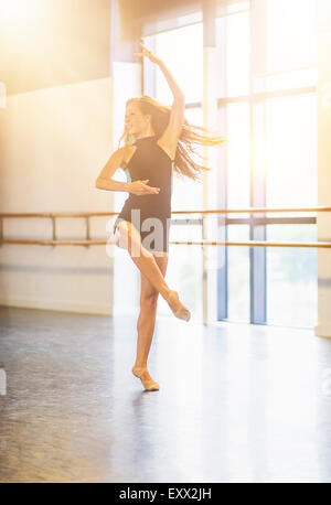 Jeune femme dansant dans un studio de danse Banque D'Images