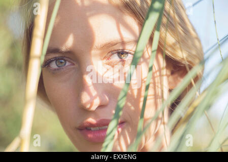 Femme partiellement obscurci par de hautes herbes Banque D'Images