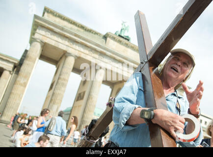 Berlin, Allemagne. 17 juillet, 2015. Prêcheur itinérant nous Arthur Blessitt se tient juste en face de la porte de Brandebourg à Berlin, Allemagne, 17 juillet 2015. Blessitt comporte toujours un d'environ 3,5 m de hauteur croix en bois avec lui dans ses voyages. Le 25 décembre 1969, il entame une tournée de 55 000 km de long, Fort Myers, Floride, USA, ce qui lui vaut une entrée dans le Guinness World Records en 2000. Photo : JOERG CARSTENSEN/dpa/Alamy Live News Banque D'Images