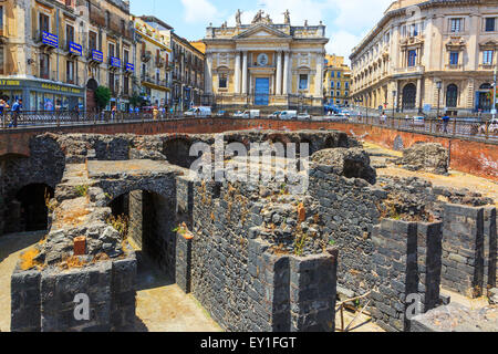 Vestiges d'un amphithéâtre romain dans le centre-ville de Catane avec l'ornate building de San Biago derrière. Sicile, Italie Banque D'Images