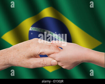 Deux mains et Brazilian flag Banque D'Images