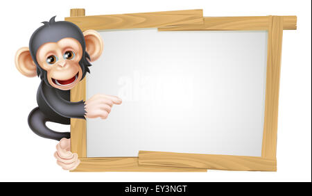 Cute cartoon singe chimpanzé comme le caractère mascot peeking autour d'un signe et pointant sur elle Banque D'Images