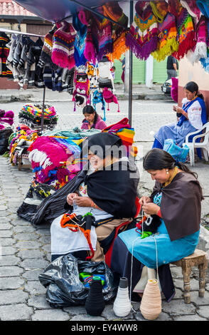 Tricot main femmes autochtones au marché local chapeaux colorés. Otavalo, Équateur. Banque D'Images