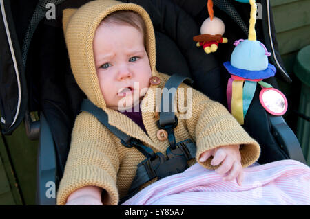 Portrait of baby girl sitting in her pram Banque D'Images