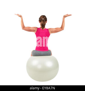 Femme sportive assis sur un ballon de gymnastique et d'entraînement à faire Banque D'Images
