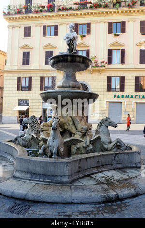 Fontaine avec un bâtiment de couleur pastel dans l'arrière-plan. Banque D'Images