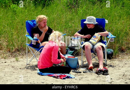 Orleans, Massachusetts : trois jeunes gens de détente sur le sable à côté de dunes herbeuses à RockHarbor Beach à Cape Cod Banque D'Images