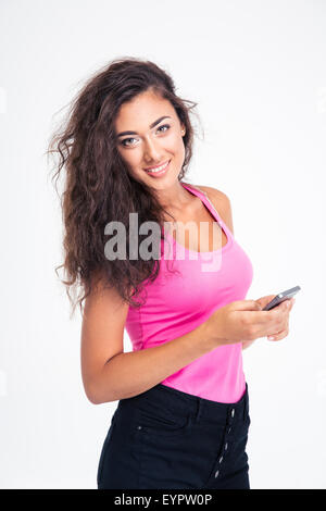 Teen girl holding smartphone et looking at camera isolé sur fond blanc Banque D'Images