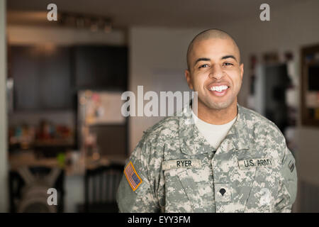 Mixed Race man smiling in living room Banque D'Images