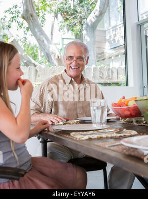 Caucasian multi-generation family eating at table Banque D'Images