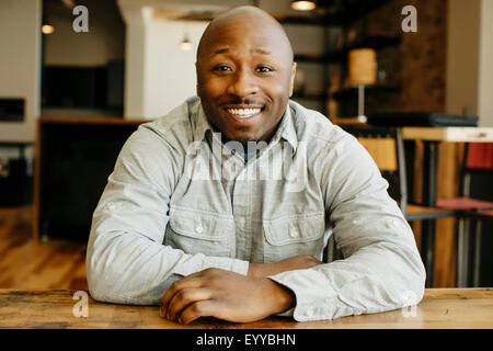 Black man smiling at counter in cafe Banque D'Images