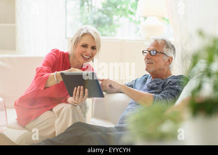 Older Caucasian woman using digital tablet in living room