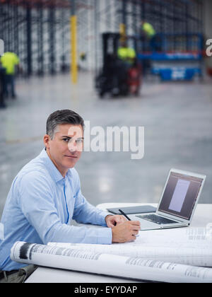 Young architect working in warehouse