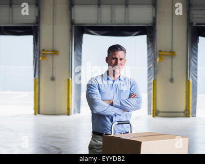 Caucasian businessman standing in warehouse Banque D'Images