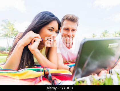 Young Woman using digital tablet in park Banque D'Images