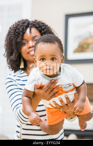 Close up of Black Mother holding baby son Banque D'Images