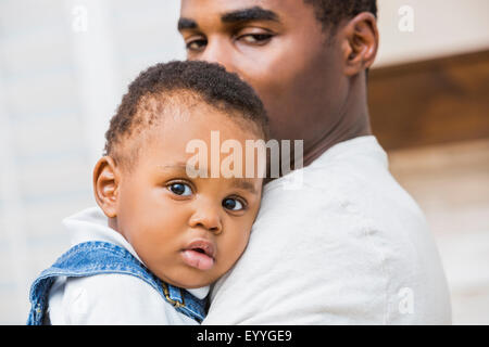 Close up of Black father holding baby son Banque D'Images