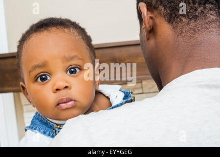 Close up of Black father holding baby son Banque D'Images