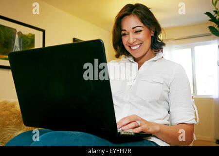 Mixed Race woman on sofa Banque D'Images