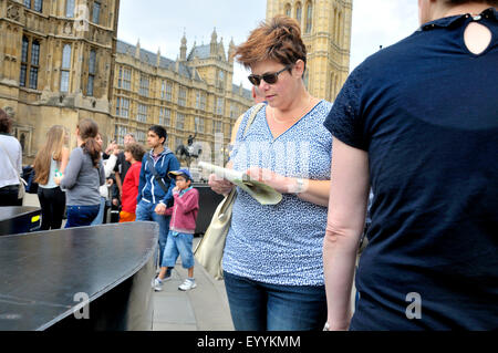 Londres, Angleterre, Royaume-Uni. Femme regardant une carte à la place du Parlement Banque D'Images