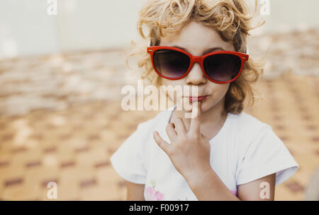 Petite fille à lunettes rouges, portrait Banque D'Images