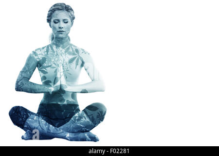 Image composite de calm blonde sitting in lotus pose avec les mains Banque D'Images