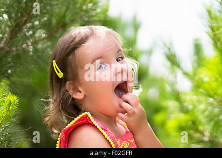 Fille avec la main sur le visage en riant Banque D'Images