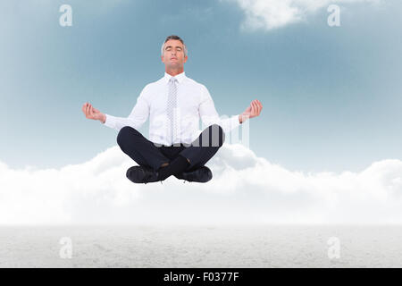 Image composite du zen businessman sitting in lotus pose Banque D'Images