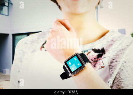 Composite image of woman using smartwatch Banque D'Images
