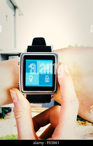 Composite image of woman using smartwatch Banque D'Images