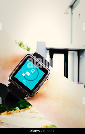 Composite image of woman using smartwatch Banque D'Images