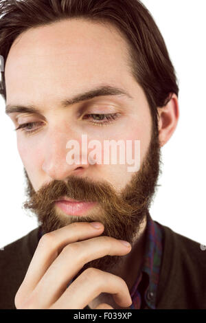 Hipster thinking with hand on chin Banque D'Images