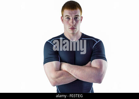 Joueur de rugby musclé avec les bras croisés Banque D'Images