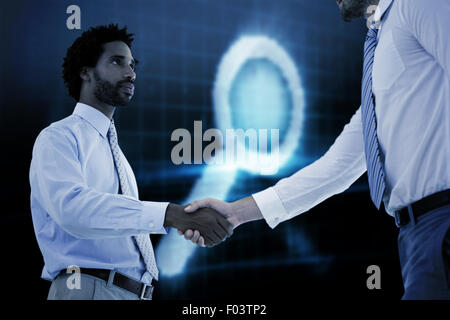 Image composite de jeunes businessmen shaking hands in office Banque D'Images