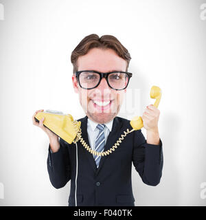 Image composite de geeky businessman holding phone Banque D'Images