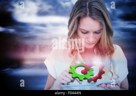 Composite image of woman using tablet pc Banque D'Images