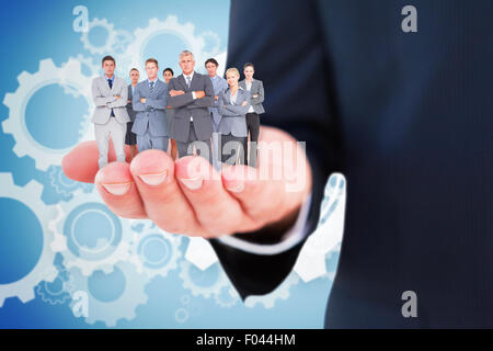 Image composite de business team standing arms crossed Banque D'Images