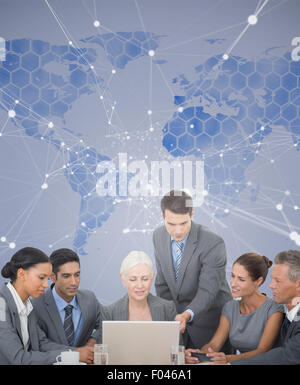 Image composite de business people using laptop Banque D'Images