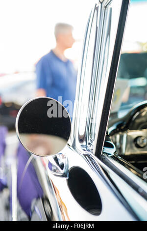 Bellmore, New York, USA. 7 août 2015. Un visiteur regarde une Noir 1958 historique Coupé Sport Biscayne, propriété de John Merrick, BROKOS de, au vendredi soir Car Show s'est tenue à l'Bellmore Long Island Railroad Station Parking. Des centaines de classique, antique, et les voitures personnalisées ont été à l'émission hebdomadaire libre, parrainé par la Chambre de Commerce de l'Bellmores. Banque D'Images