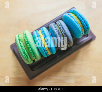 Macarons colorés sur le plateau en plastique avec vintage filtré pastel Banque D'Images